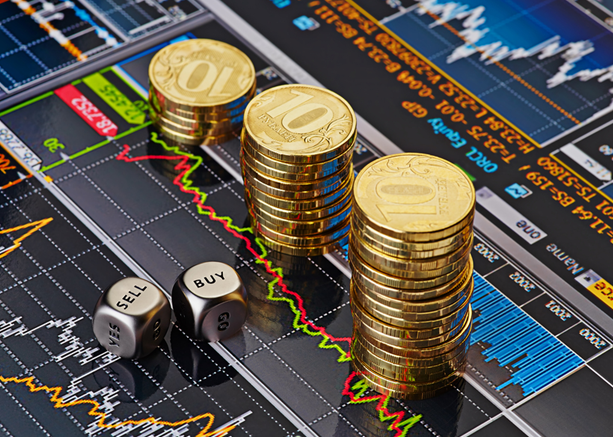 a graphic of 3 piles of gold coins stacked-up next to each other next to two silver dice that have both Sell and Buy facing upwards all on top of stock market display screen representing how to sell a business