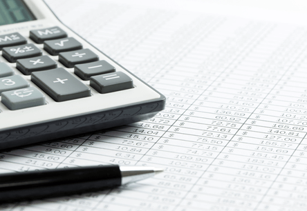 calculator and pen for debt settlement advice