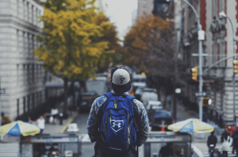 boy looking at road with cheap backpacks